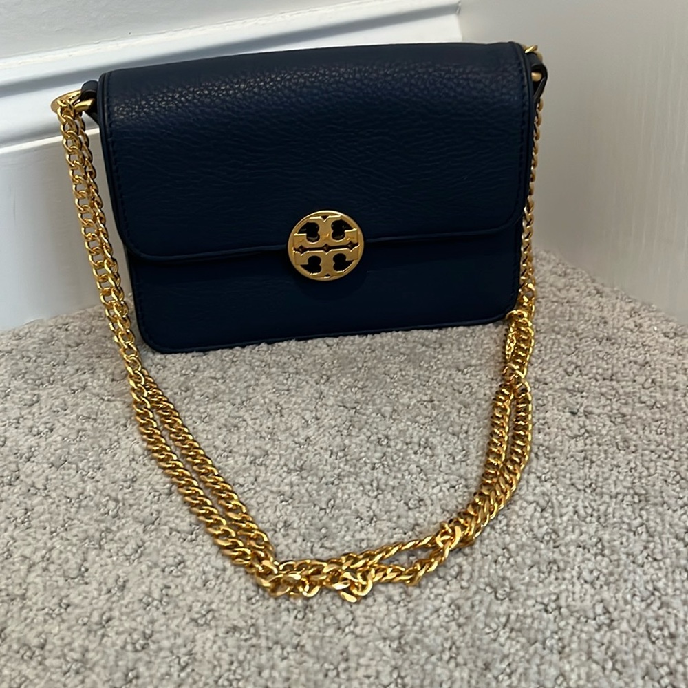 Never worn Tory Burch navy bag with gold chain.